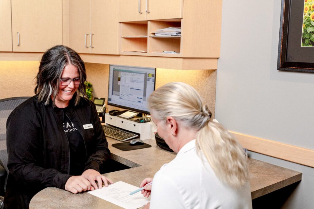 orthodontist fargo&mdash;treatment coordinator reviewing paperwork